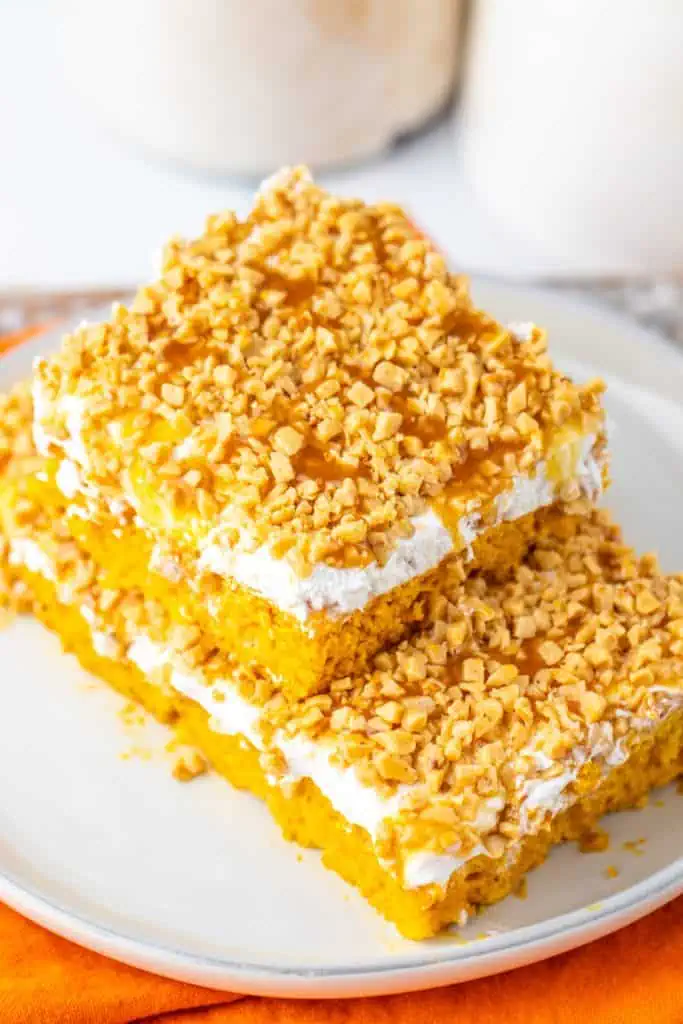 Slice of Pumpkin Better Than Sex Cake with caramel drizzle and toffee bits