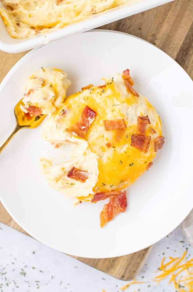 Serving of cheesy mashed potatoes on a plate