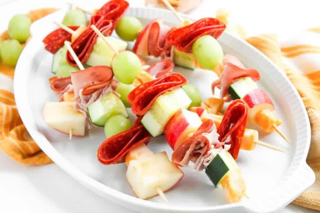 Close-up of a snack skewer with folded ham, pepperoni, and Colby Jack