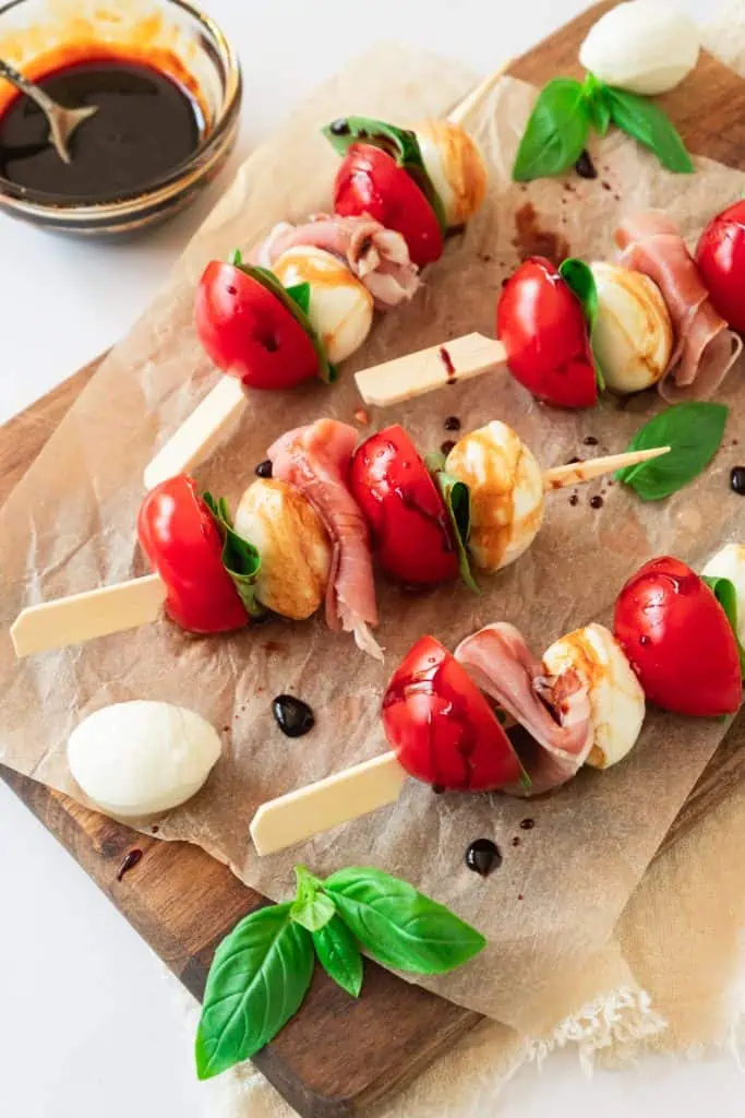 Party-ready Caprese skewers with prosciutto and basil for summer entertaining.