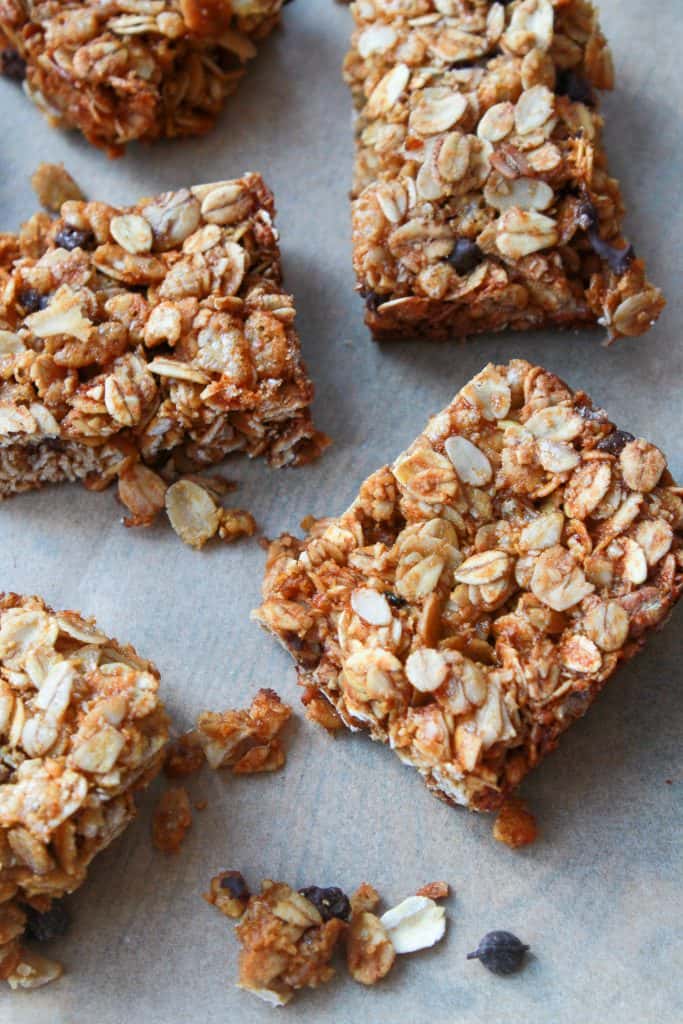 Close-up of a sliced honey oat granola bars showing the chewy oat texture with visible chocolate chips and crispy rice cereal throughout.