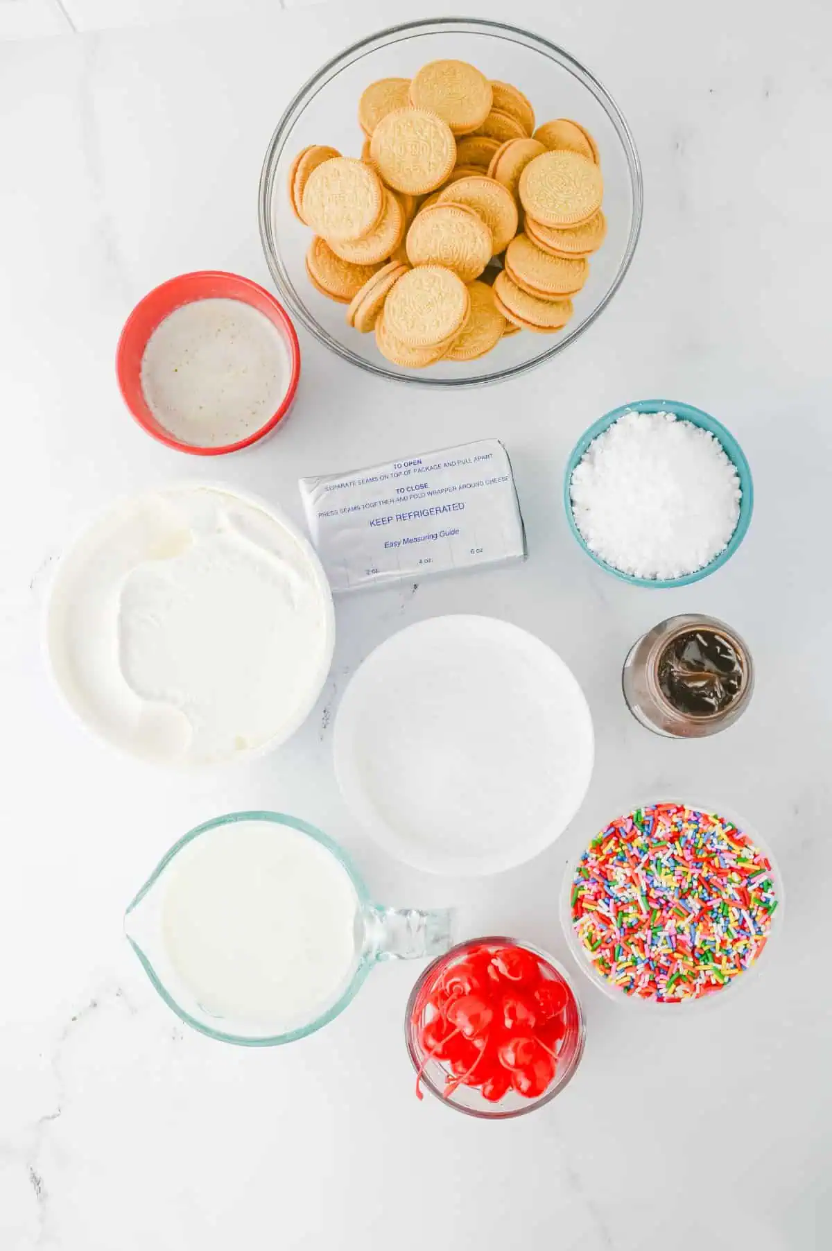 Golden Oreos, banana pudding, cream cheese, whipped topping, butter, fudge sauce, sprinkles, and cherries arranged for Banana Split Lush.