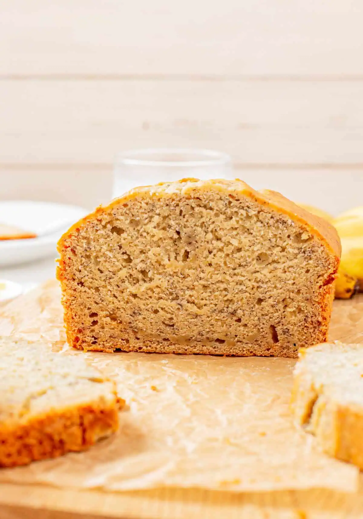 Close-up of a sliced piece of banana bread showing a soft, moist crumb