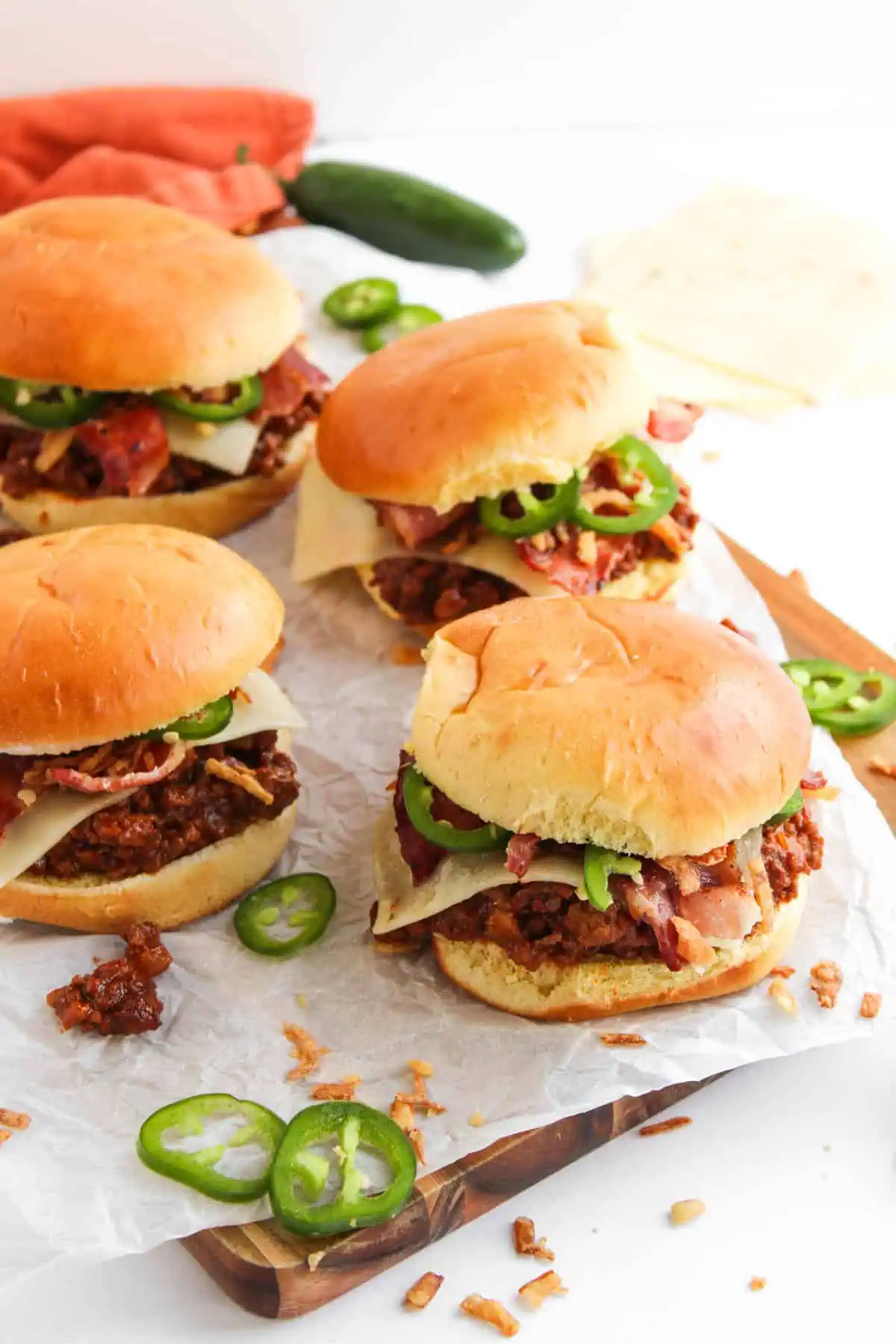loaded BBQ cowboy sloppy joes on a toasted brioche buns with bacon, cheese, jalapenos, cheddar jack cheese, and crispy onions