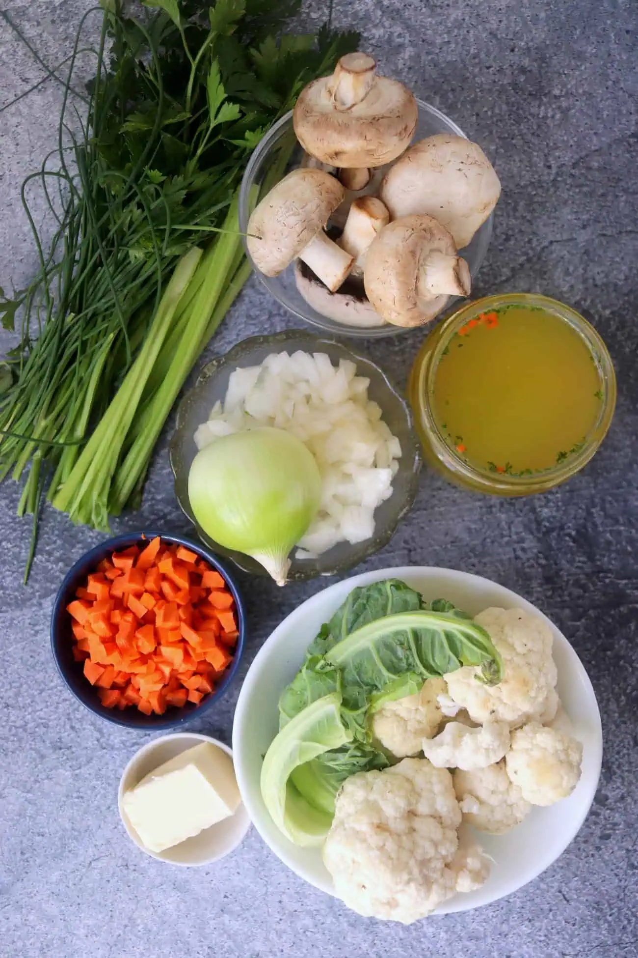 Cauliflower, mushrooms, carrots, celery, onions, fresh herbs, butter, and broth for cauliflower stuffing.