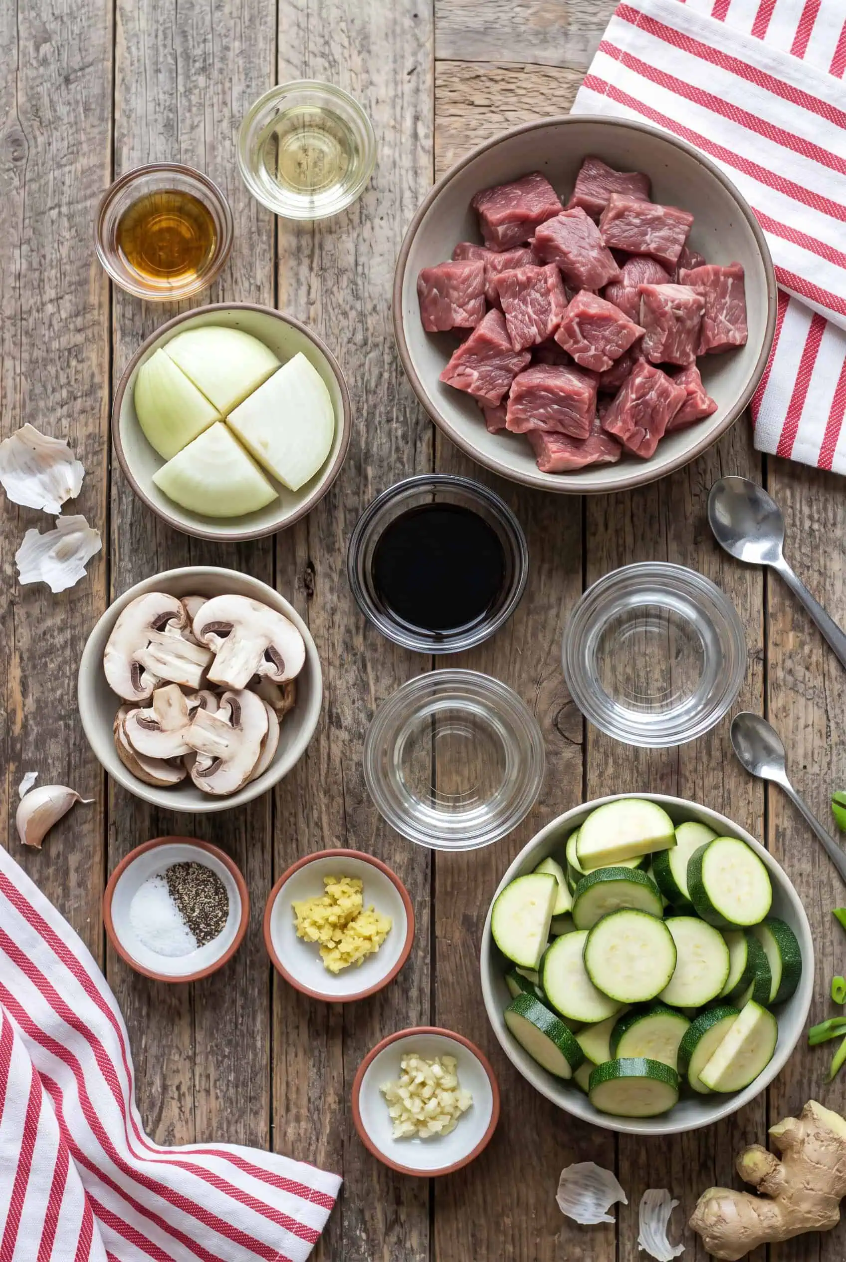 Flank steak, mushrooms, onion, zucchini, broth, soy sauce, ginger, and garlic for Instant Pot hibachi steak bites.